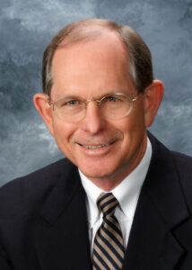 white middle aged man in glasses with receding hairline suit and jacket