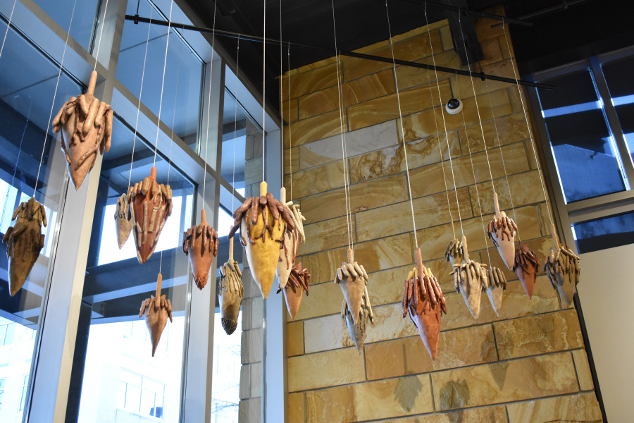 mobile hanging from ceiling with cone shaped artwork on strings