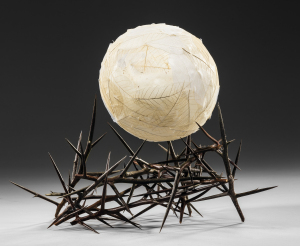 white sphere held by pointy branches