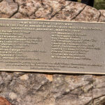 bronze plaque with names on rock