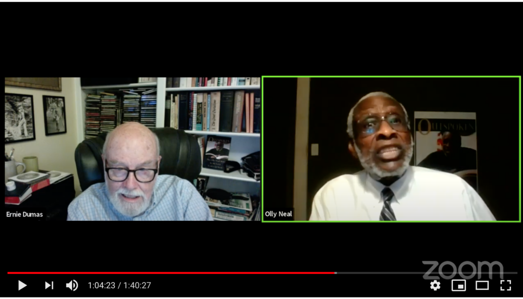 zoom screen shot of white man with beard and glasses on the left with book shelves behind and a Black man with glasses and beard on the right