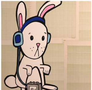 white rabbit wearing a frown and headphones