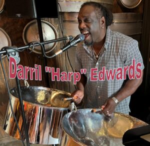 black man with steel drums singing into a microphone