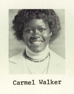 smiling black teenage girl with curly hair wearing white turtleneck and jacket