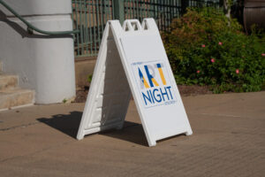 sandwich board on sidewalk with words "art night"
