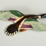 Wooden lacquer pin of a bird in flight