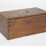 Large wooden box closed with three metal pieces