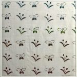 Repeating pattern of winged insect and flowers on fabric