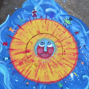 Sun with face and people walking on it on blue background