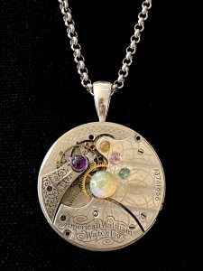 Round clockwork pendant necklace on display