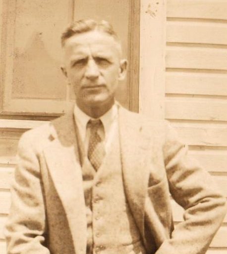 sepia toned photo of white man in suit