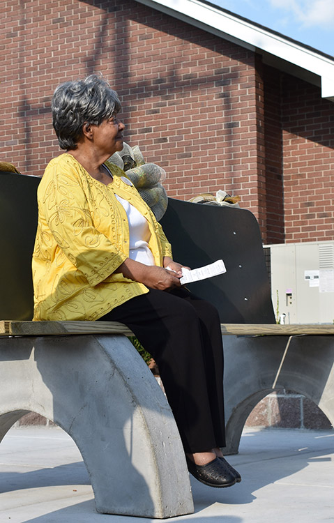 Older African-American woman sitting on bench