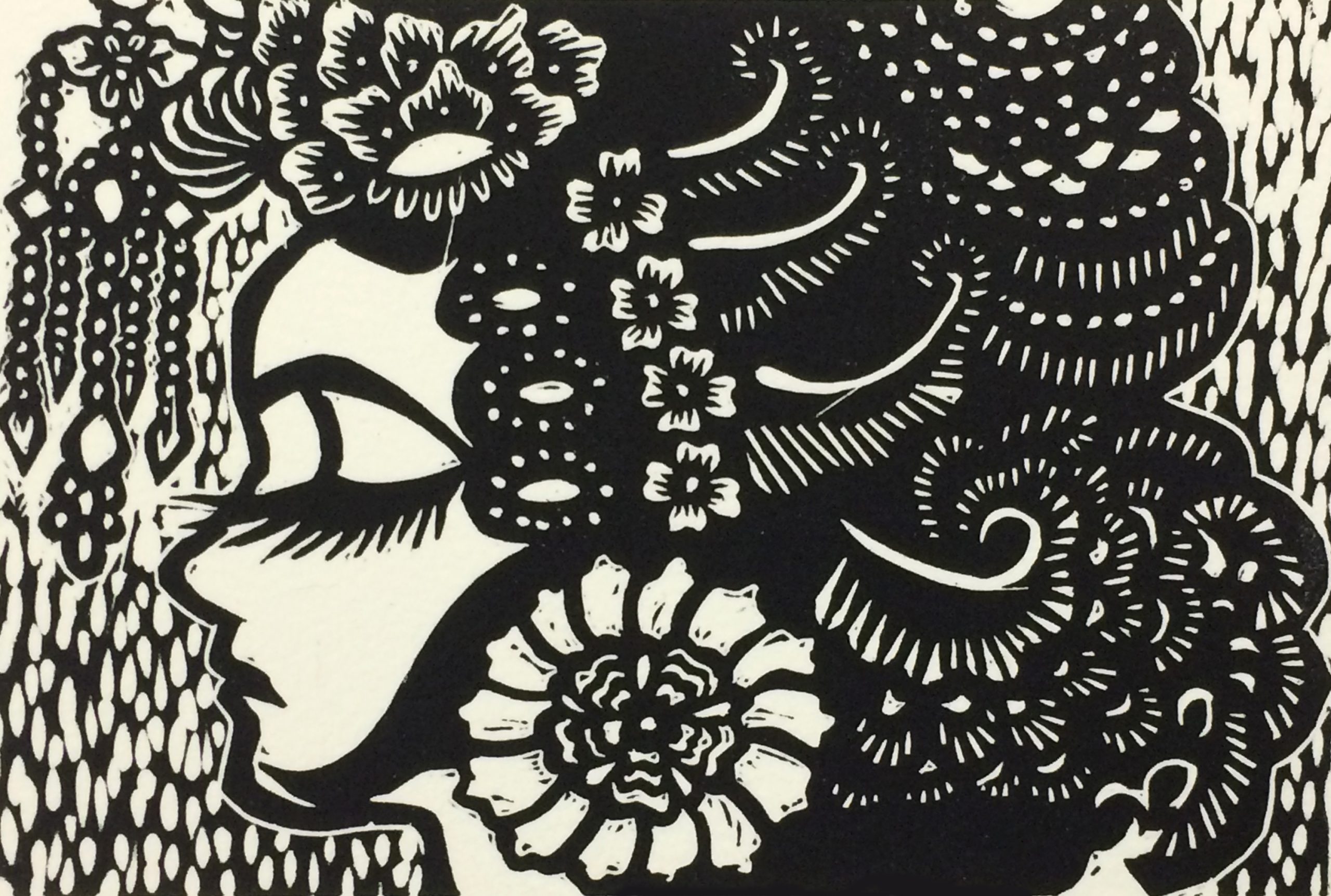 Black and white print of profile of women face. Hair has flowers and texture.