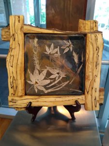 Framed floral artwork on display stand