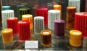 Multicolored candles in glass display case