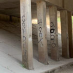 "Covid Hoax 2020" spray painted on bridge support columns