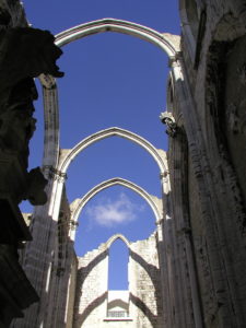 four white arches with blue sky above