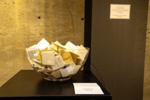 glass bowl with folded pieces of paper in it