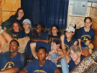 African American and white teens in blue t-shirts posing for a group photo